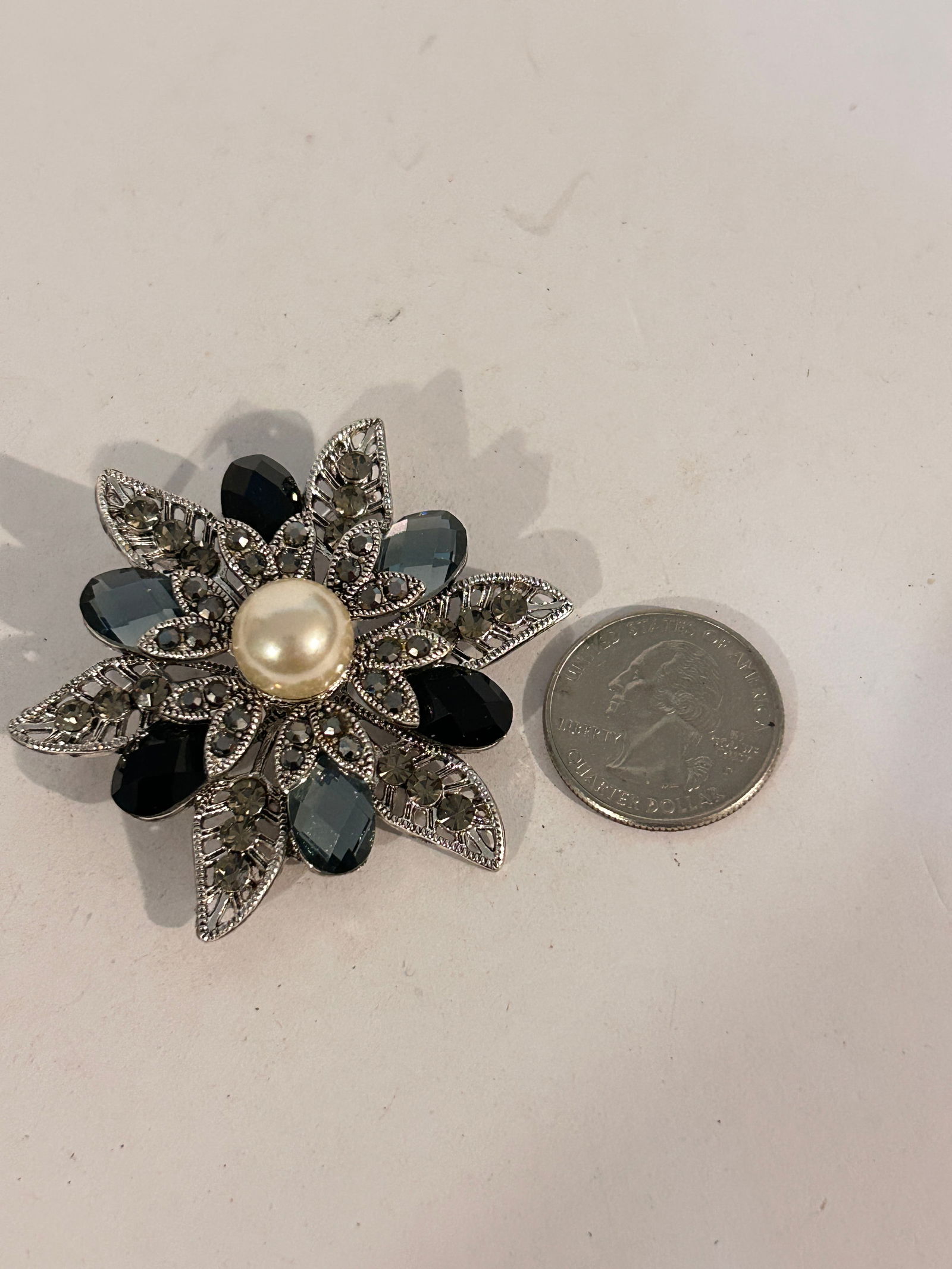Vintage Marcasite Silvertone faux pearl flower Brooch: Vintage Marcasite Silvertone faux pearl flower Brooch Please view all photos as they are part of the description and condition of this Item, Feel free to contact me with questions or picture requests!