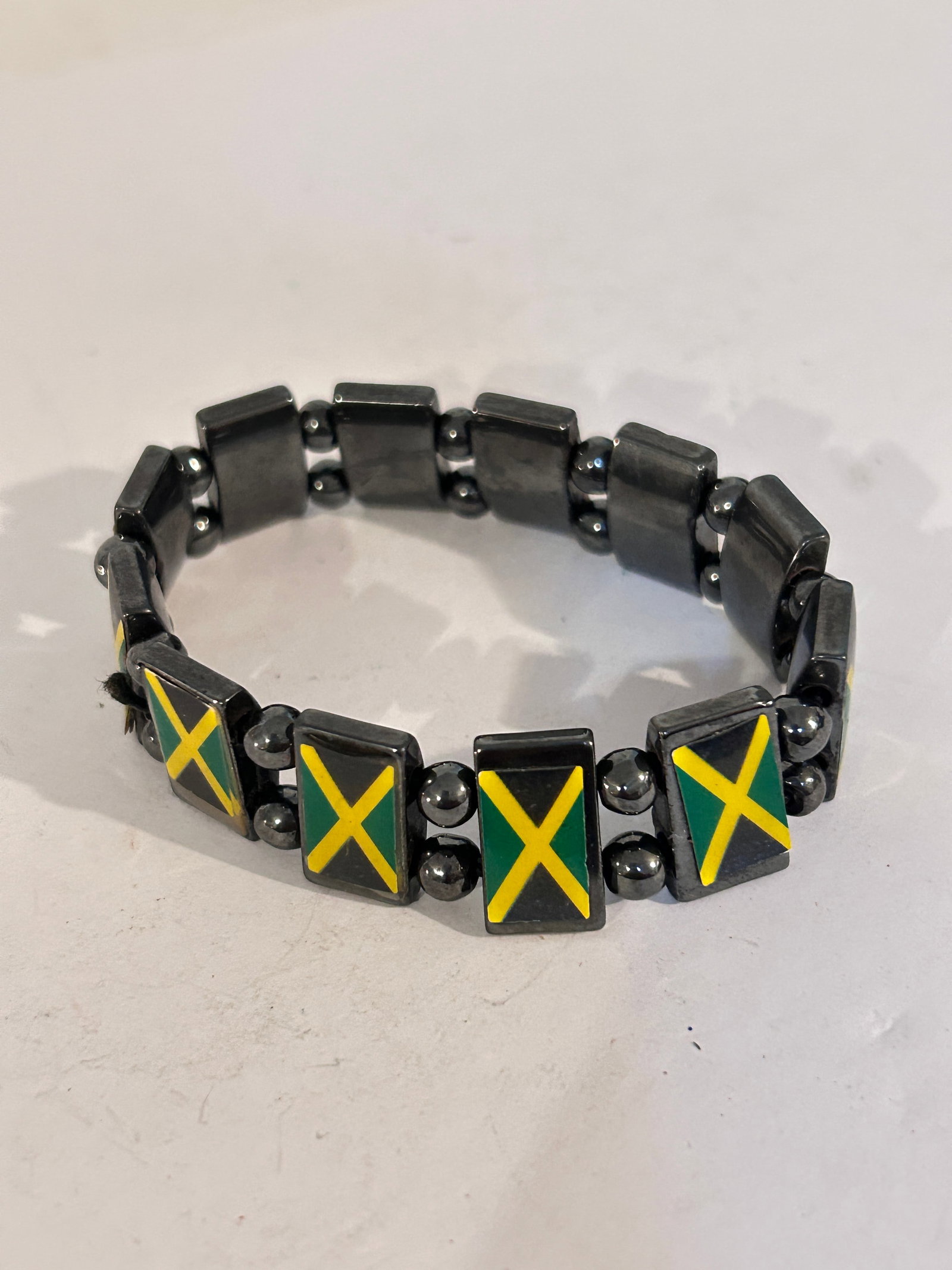 Vintage Hematite/black Jamaican Flag stretch Bracelet: Vintage Hematite/black Jamaican Flag stretch Bracelet Please view all photos as they are part of the description and condition of this Item, Feel free to contact me with questions or picture requests!