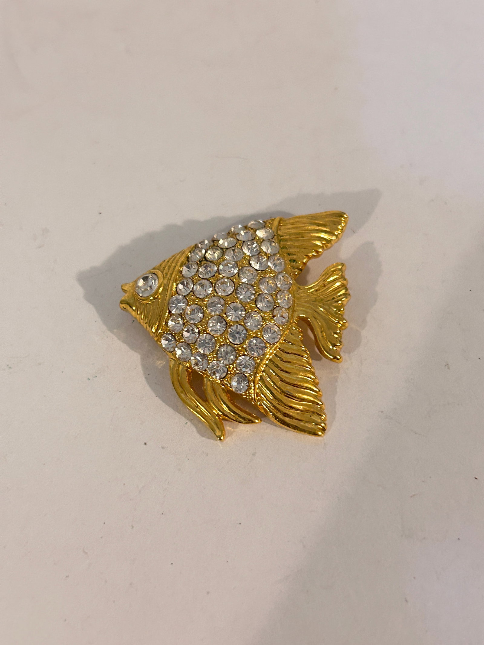 Vintage Gold tone Rhinestone fish Brooch: Vintage Gold tone Rhinestone fish Brooch Please view all photos as they are part of the description and condition of this Item, Feel free to contact me with questions or picture requests! Used Item AS