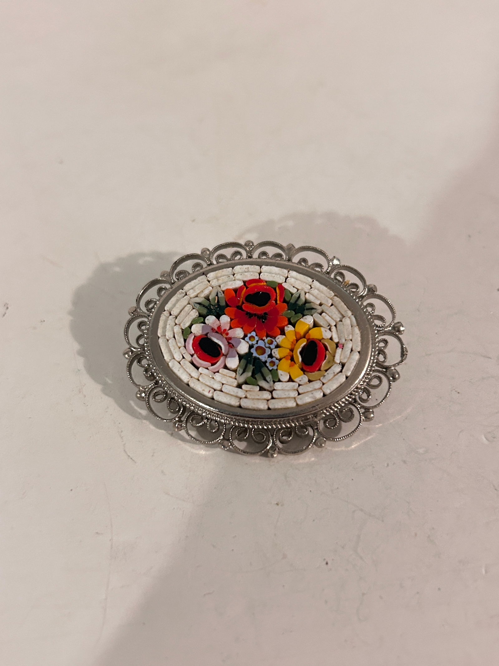 Vintage italian mosaic Brooch: Vintage italian mosaic Brooch Please view all photos as they are part of the description and condition of this Item, Feel free to contact me with questions or picture requests! Used Item AS IS