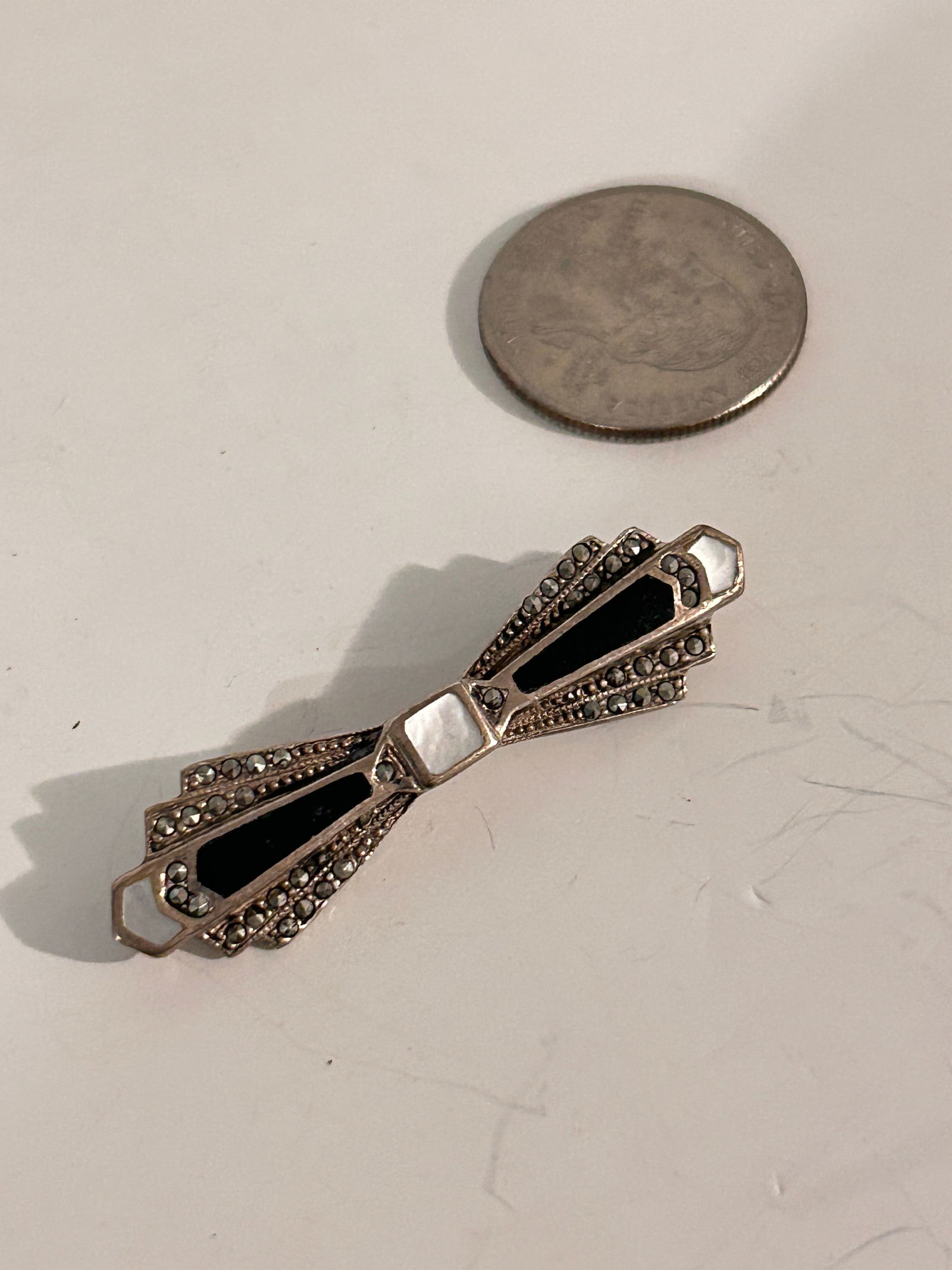 Vintage Sterling Silver mother of pearl onyx marcasite Brooch: Item comes exactly as shown Know what you are bidding on. Carefully refer to and examine all photos, ask questions, do research, etc., to determine (Authinticity) . before bidding in order to determin