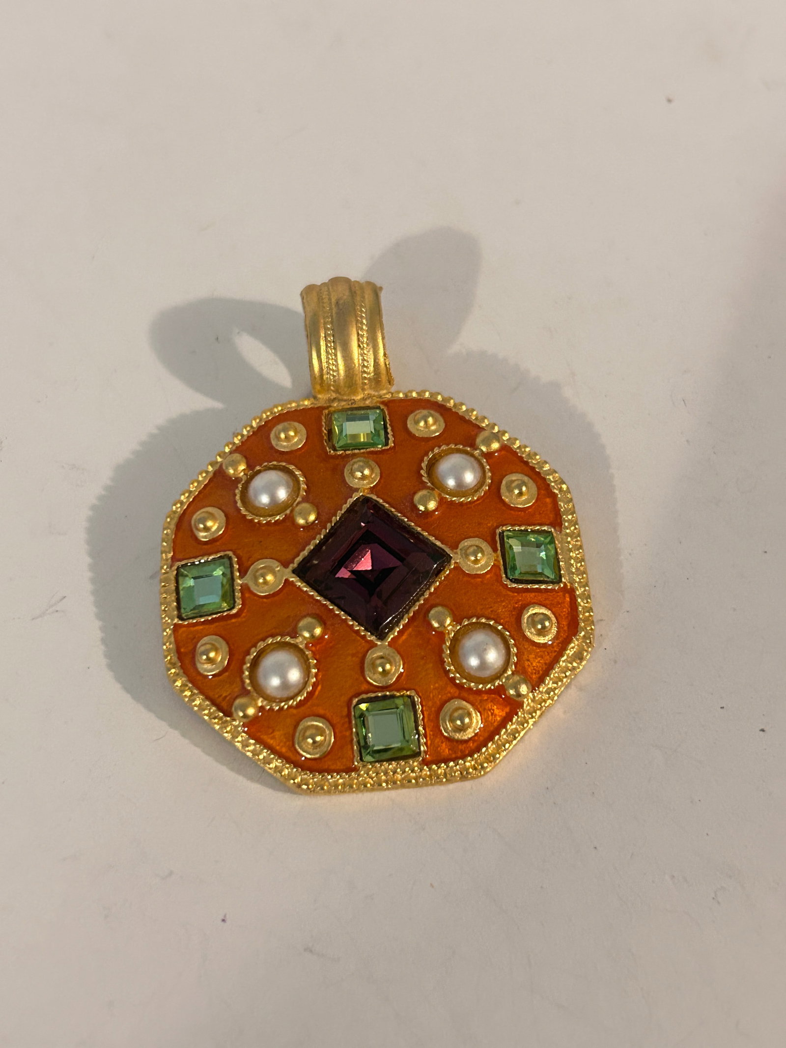 Vintage Craft octagonal pendant with orange enamel, faux pearls, green stones, and a central purple: Vintage Craft octagonal pendant with orange enamel, faux pearls, green stones, and a central purple stone Please view all photos as they are part of the description and condition of this Item, Feel fr