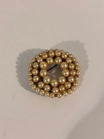 This is a vintage faux pearl brooch