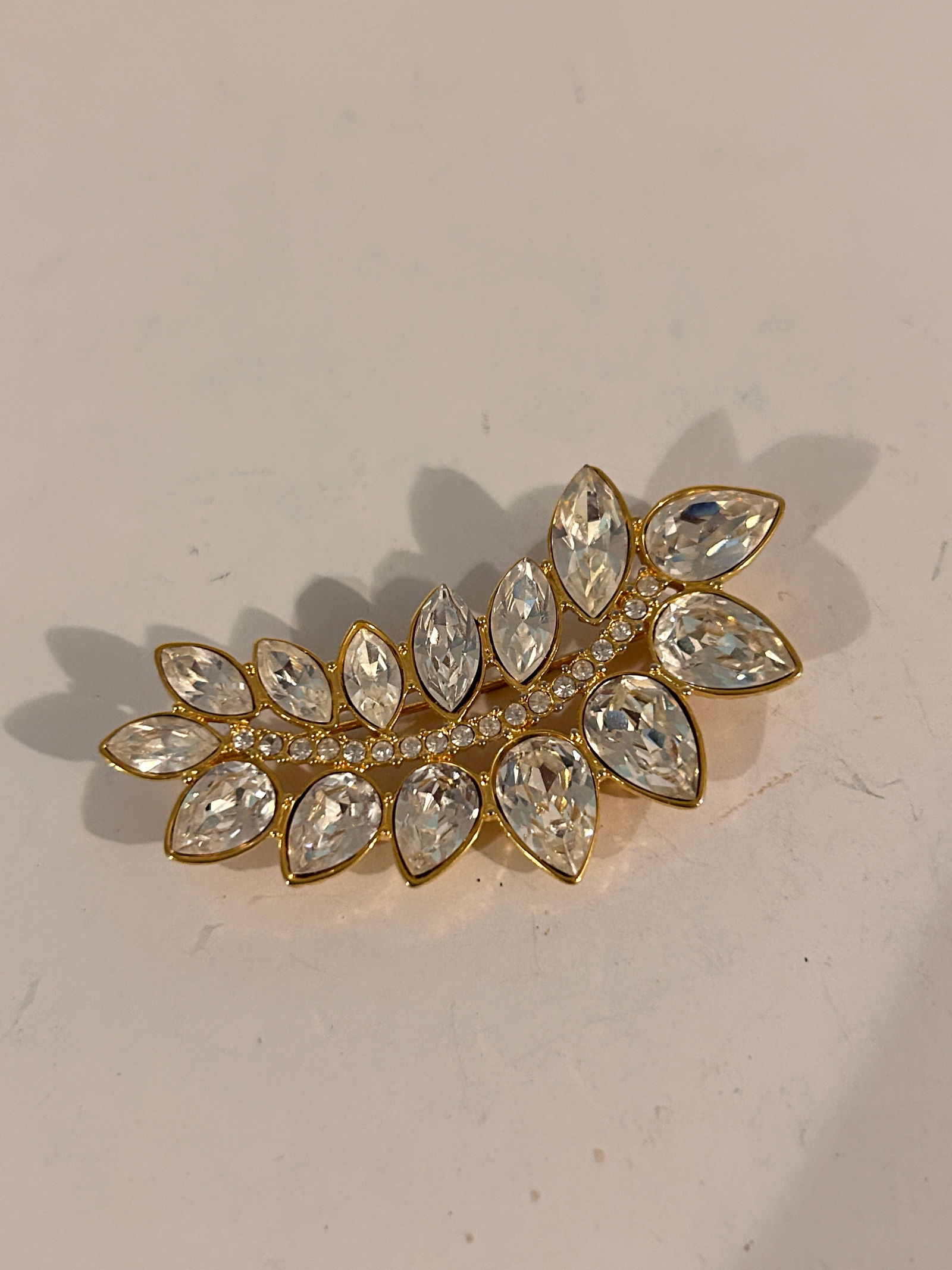 Vintage rhinestone Monet Goldtone Brooch: Vintage rhinestone Monet Goldtone Brooch Please view all photos as they are part of the description and condition of this Item, Feel free to contact me with questions or picture requests! Used Item AS
