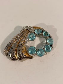 Vintage 1920s Brooch featuring blue rhinestones and silver-tone metal design.