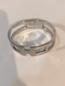 Vintage Tommy Hilfiger Women's H Bangle hinged stainless steel bracelet.