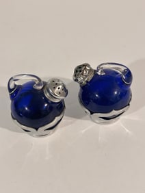 Vintage cobalt blue glass tilt salt and pepper shakers, likely manufactured by the Cambridge Glass