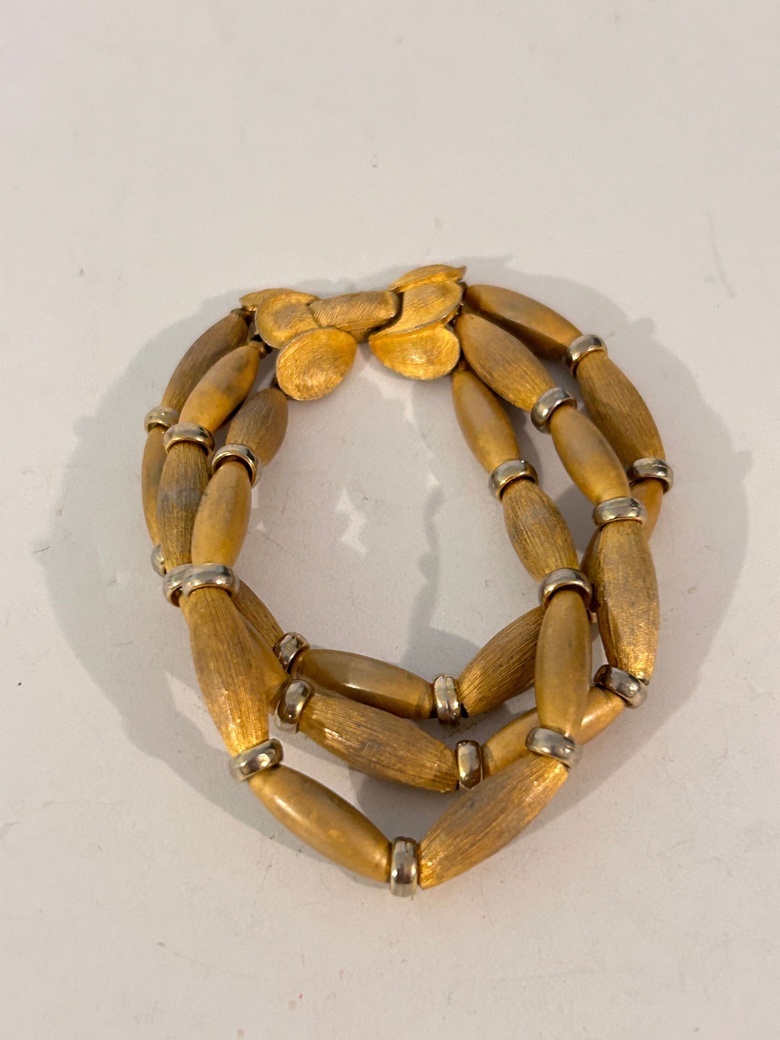 Vintage Unsigned Kramer 1960s 3 Strand Gold Bead Bracelet: Vintage Unsigned Kramer 1960s 3 Strand Gold Bead Bracelet Please view all photos as they are part of the description and condition of this Item, Feel free to contact me with questions or picture reque