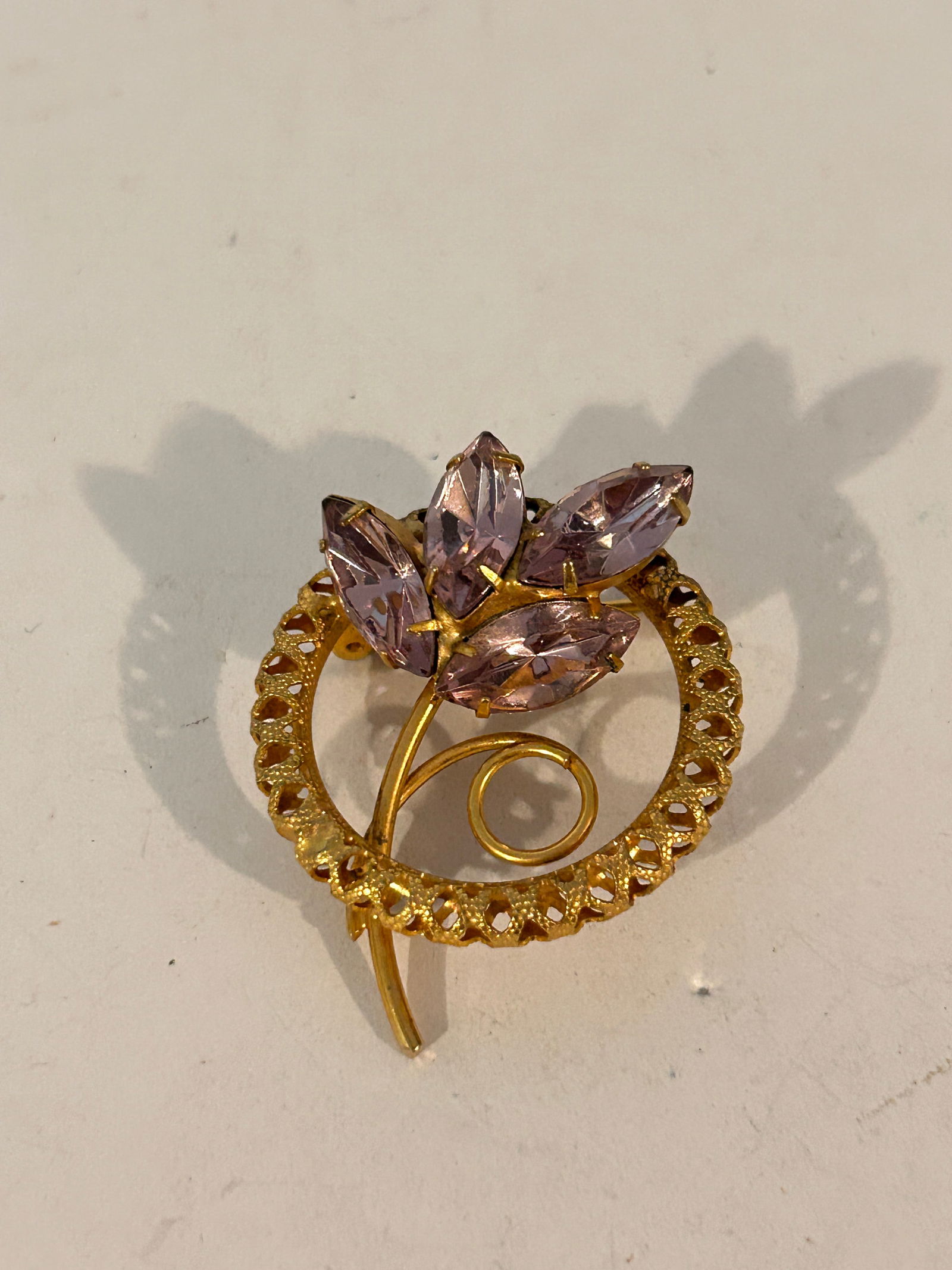 Vintage goldtone filigree purple rhinestone Brooch: Vintage goldtone filigree purple rhinestone Brooch Please view all photos as they are part of the description and condition of this Item, Feel free to contact me with questions or picture requests! Us