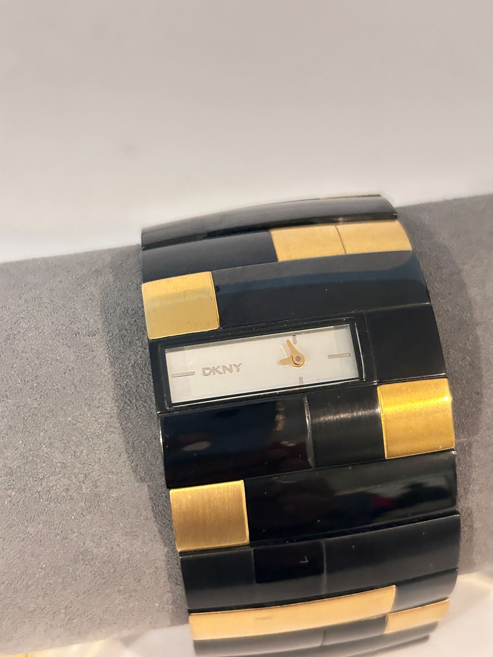 DKNY NY4378 ladies bangle watch featuring a two-tone yellow gold-toned and black band working (1 of 6)