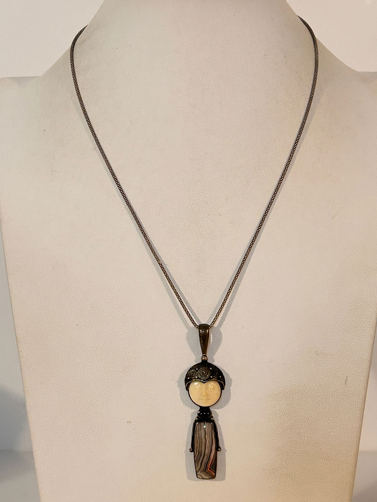 Sajen carved face, garnet and agate pendant with chains: Sajen carved face, garnet and agate pendant with chains Please view all photos as they are part of the description and condition of this Item, Feel free to contact me with questions or picture request