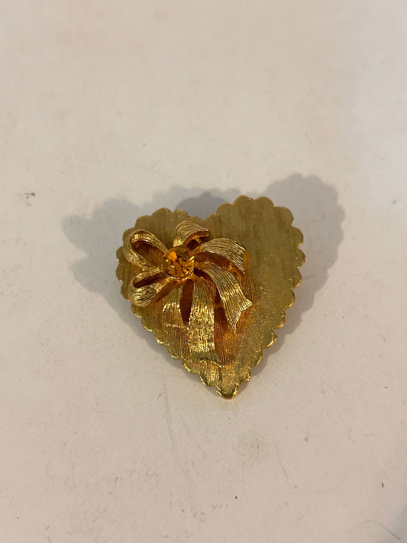 Vintage Gold Tone rhinestone heart Brooch: Vintage Gold Tone rhinestone heart Brooch Please view all photos as they are part of the description and condition of this Item, Feel free to contact me with questions or picture requests! Used Item A