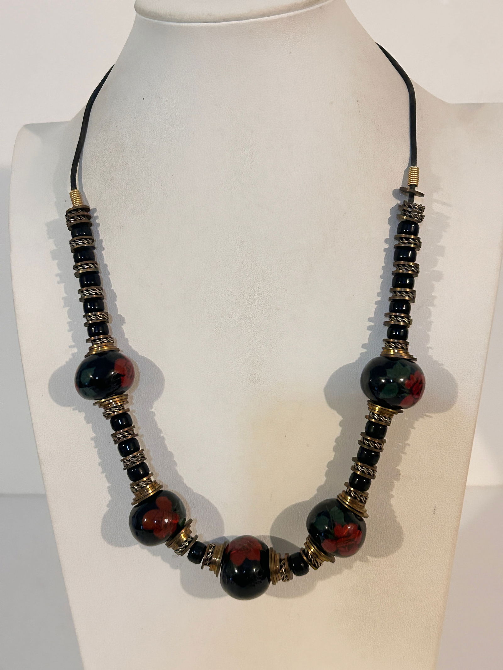 Vintage brass and black ceramic bead necklace with a floral motif 23": Vintage brass and black ceramic bead necklace with a floral motif 23" Please view all photos as they are part of the description and condition of this Item, Feel free to contact me with questions or p