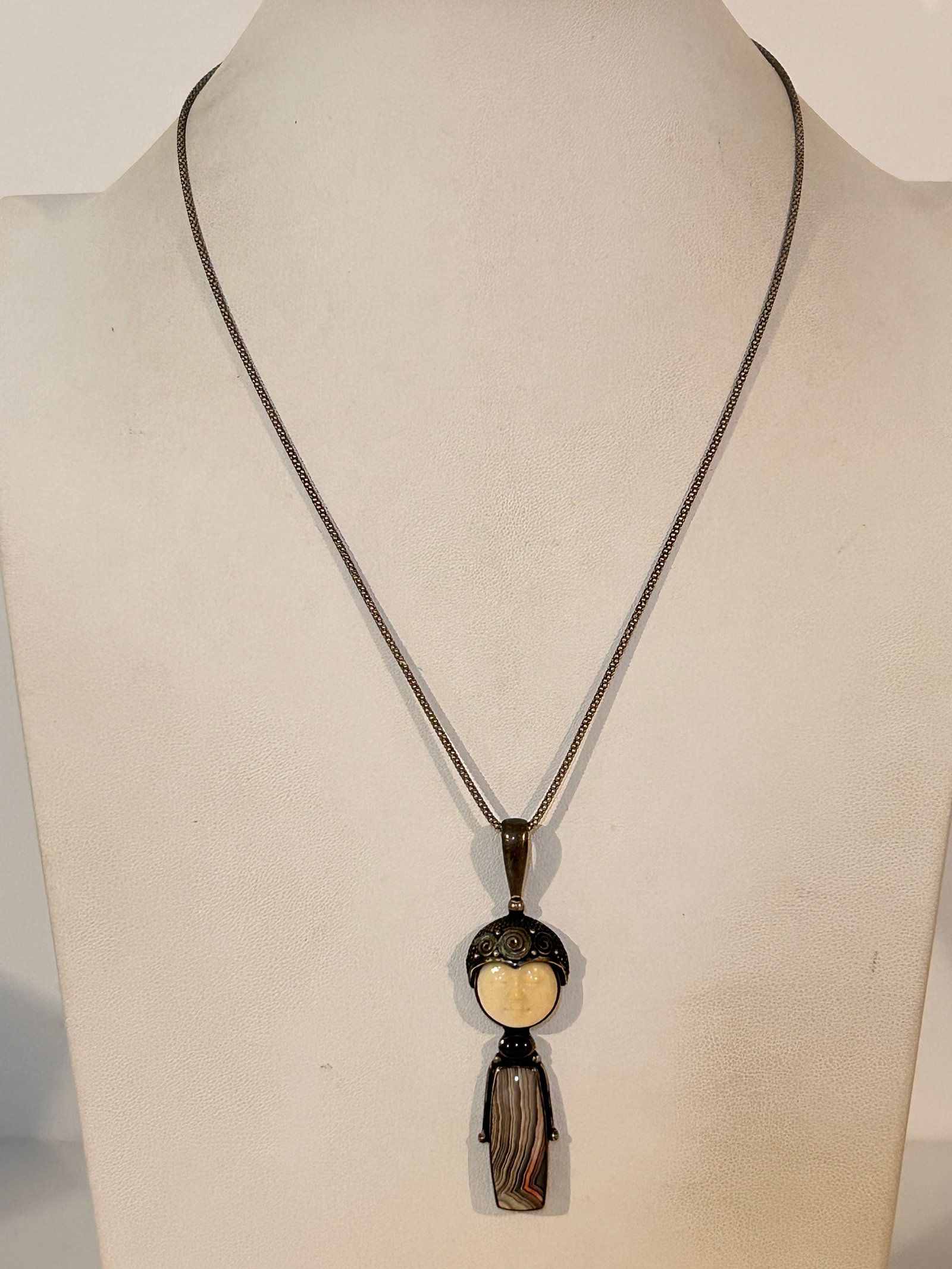 Sajen carved face, garnet and agate pendant with chains: Sajen carved face, garnet and agate pendant with chains Please view all photos as they are part of the description and condition of this Item, Feel free to contact me with questions or picture request