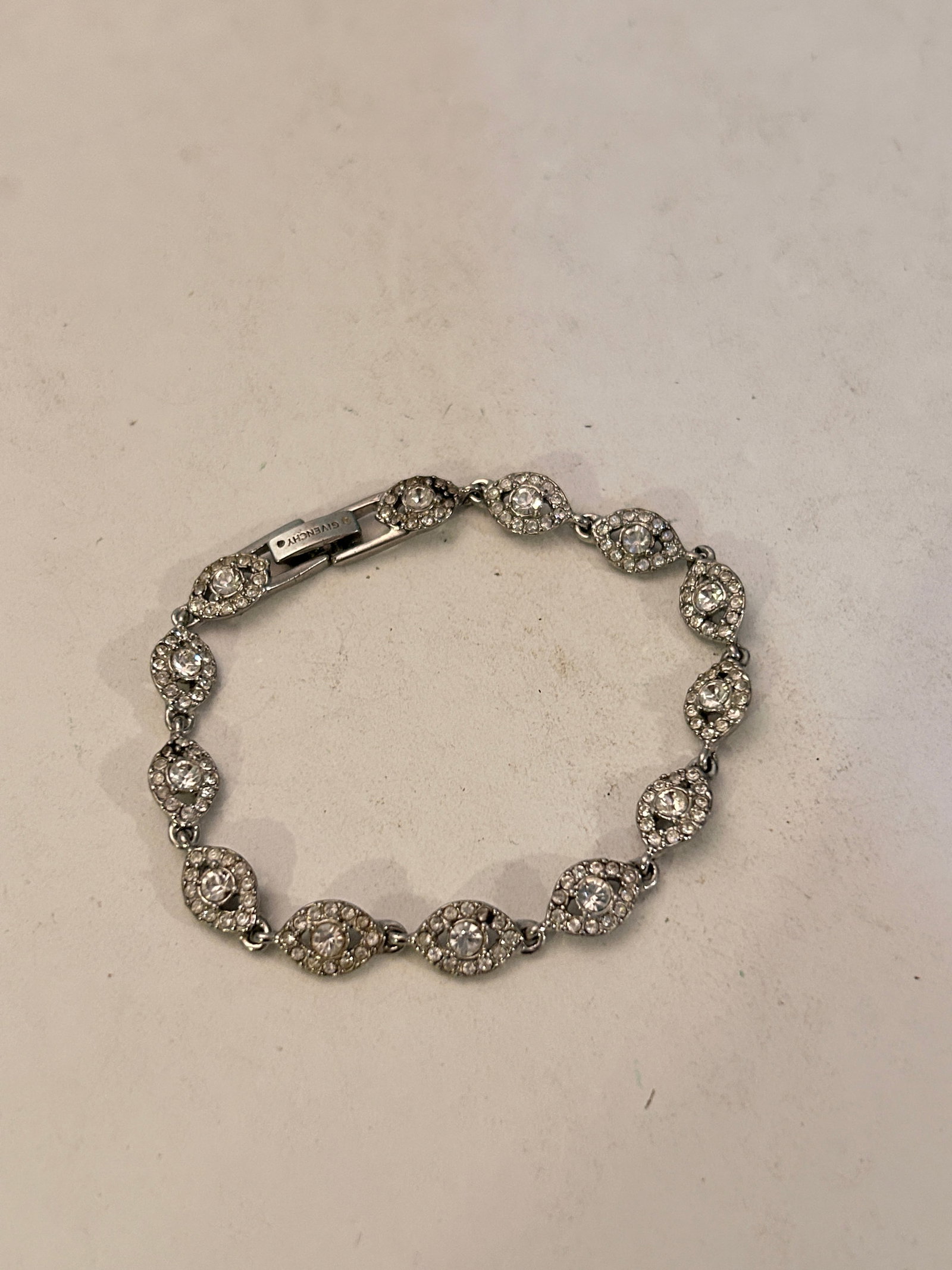Givenchy Crystal Evil Eye Bracelet 7": Givenchy Crystal Evil Eye Bracelet 7" Please view all photos as they are part of the description and condition of this Item, Feel free to contact me with questions or picture requests! Used Item AS IS