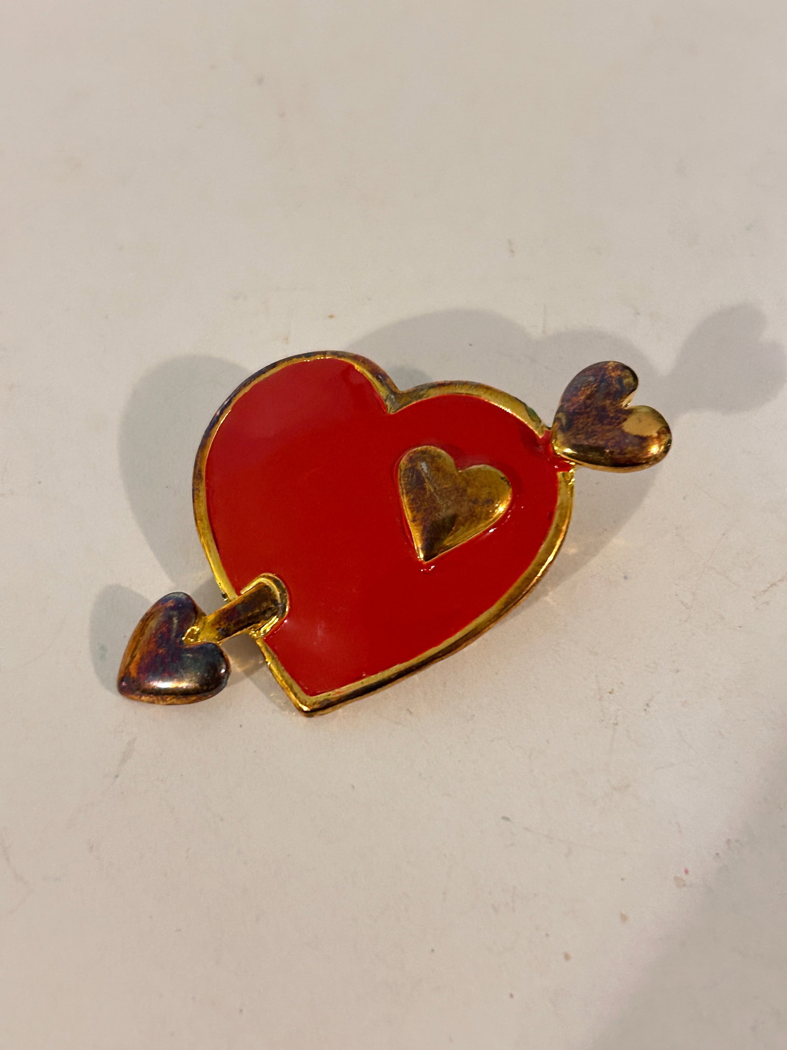 Vintage red enamel cupid heart Brooch: Vintage red enamel cupid heart Brooch Please view all photos as they are part of the description and condition of this Item, Feel free to contact me with questions or picture requests! Used Item AS IS