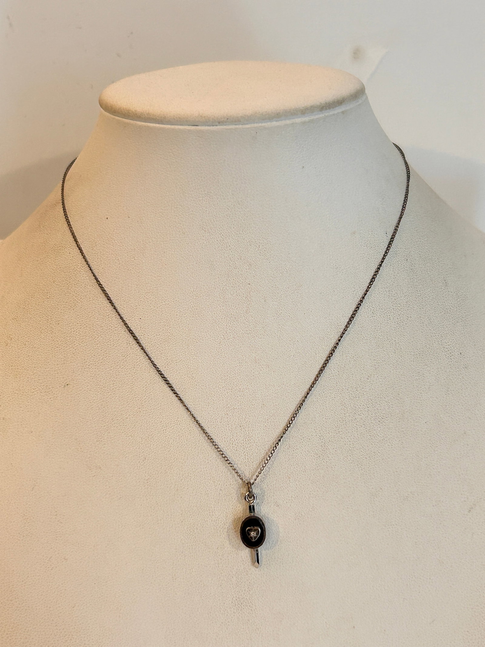 Vintage Sterling Silver pendant with a black enamel center and a small heart 15": Vintage Sterling Silver pendant with a black enamel center and a small heart 15" Please view all photos as they are part of the description and condition of this Item, Feel free to contact me with que
