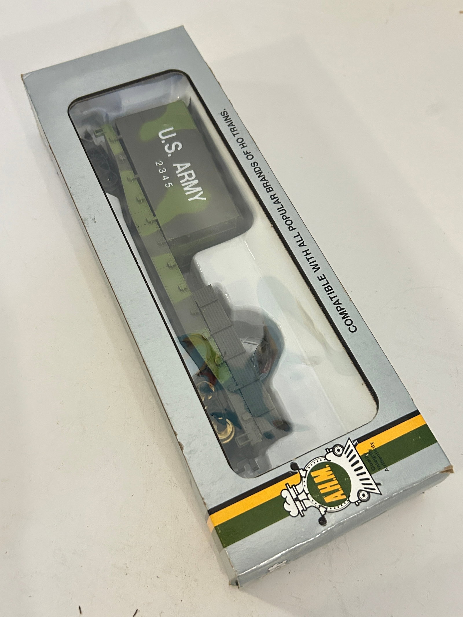 AHM HO scale model is a U.S. Army flatcar set featuring a truck and trailer (1 of 4)