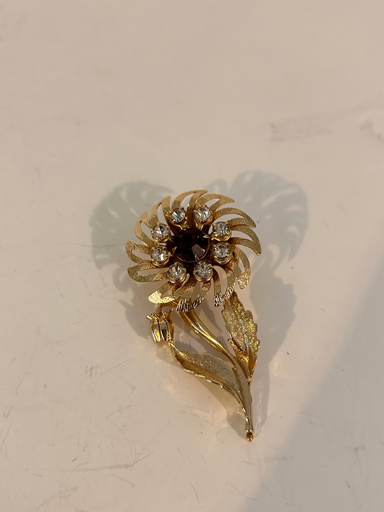vintage Brooch features a gold-tone floral design