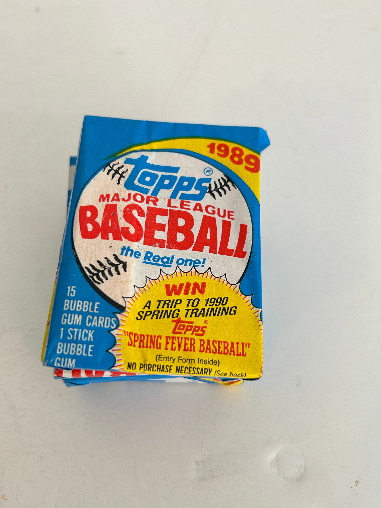 Unopened 1989 Topps Major League Baseball wax pack featuring a "Spring Fever Baseball" (1 of 2)