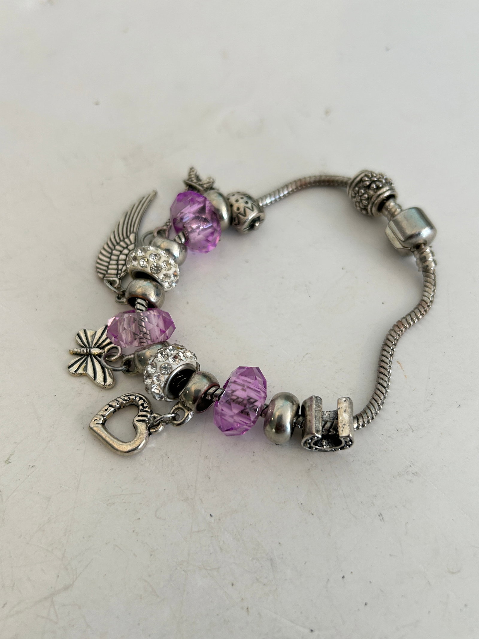Vintage charm bracelet featuring purple crystal faceted beads 7": Vintage charm bracelet featuring purple crystal faceted beads 7" Please view all photos as they are part of the description and condition of this Item, Feel free to contact me with questions or pictur