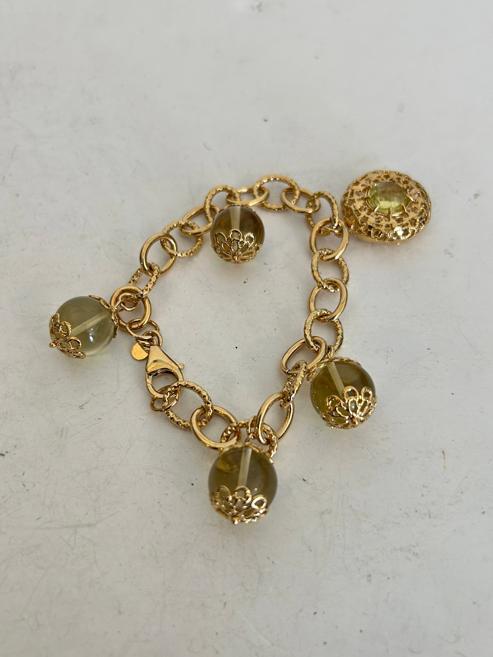 Vintage Filigree Gold Tone Glass Ball Charm Bracelet 7": Vintage Filigree Gold Tone Glass Ball Charm Bracelet 7" Please view all photos as they are part of the description and condition of this Item, Feel free to contact me with questions or picture request