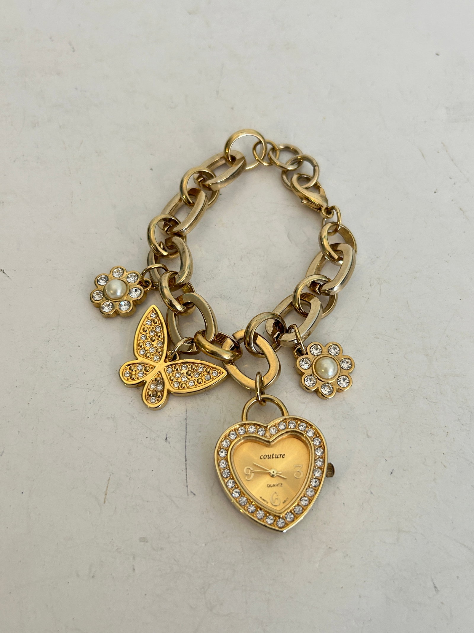 Vintage Juicy Couture Gold Charm Watch Bracelet working: Vintage Juicy Couture Gold Charm Watch Bracelet working Please view all photos as they are part of the description and condition of this Item, Feel free to contact me with questions or picture request