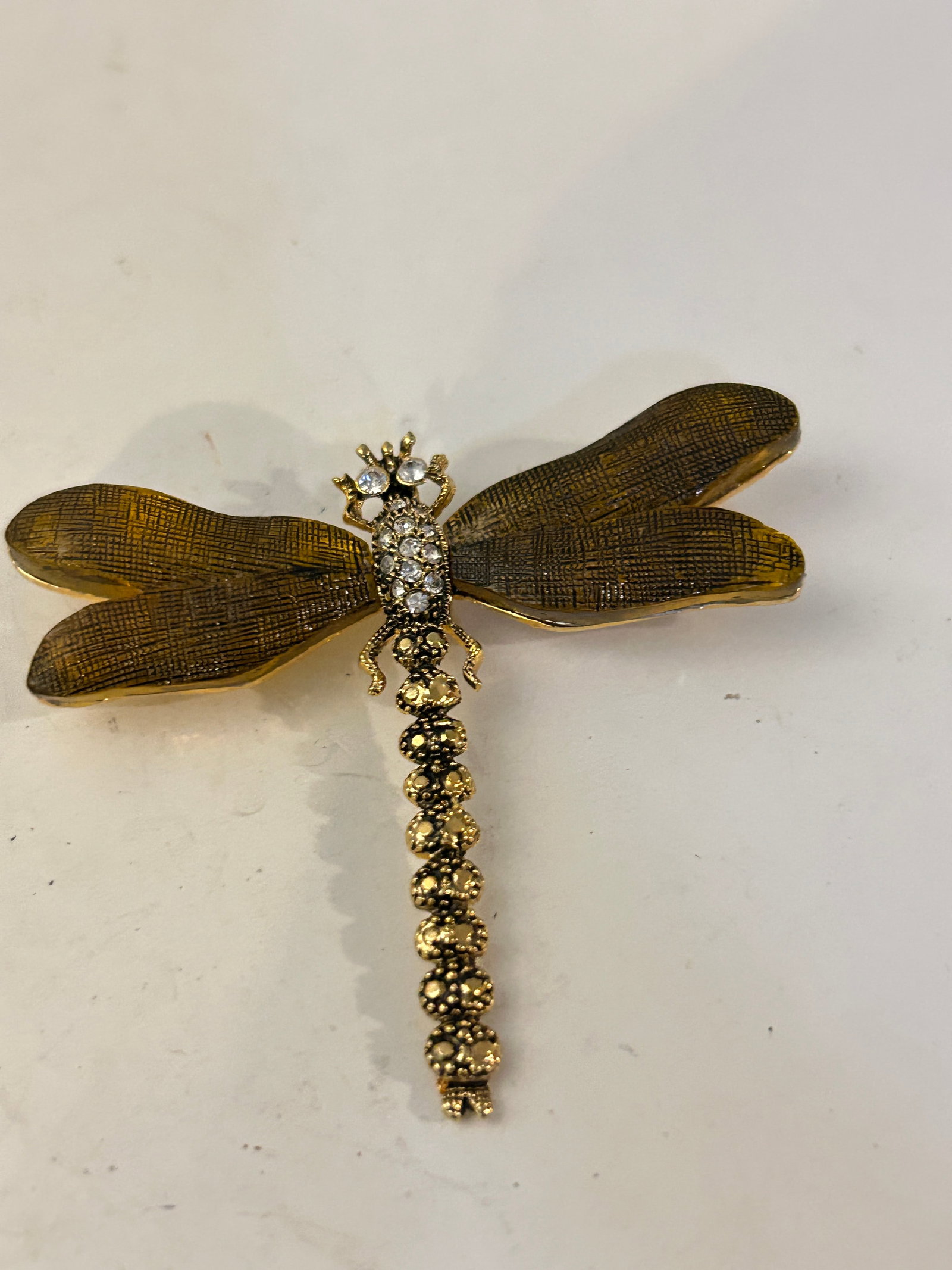 Vintage antiqued gold-tone dragonfly Brooch: Vintage antiqued gold-tone dragonfly Brooch Please view all photos as they are part of the description and condition of this Item, Feel free to contact me with questions or picture requests! Used Item