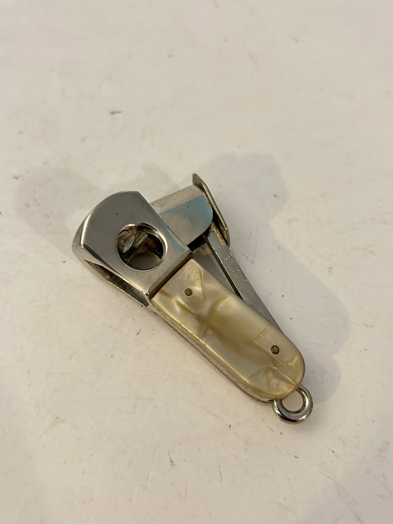 vintage Mother of Pearl Solingen mini cigar cutter: vintage Mother of Pearl Solingen mini cigar cutter Please view all photos as they are part of the description and condition of this Item, Feel free to contact me with questions or picture requests! Us