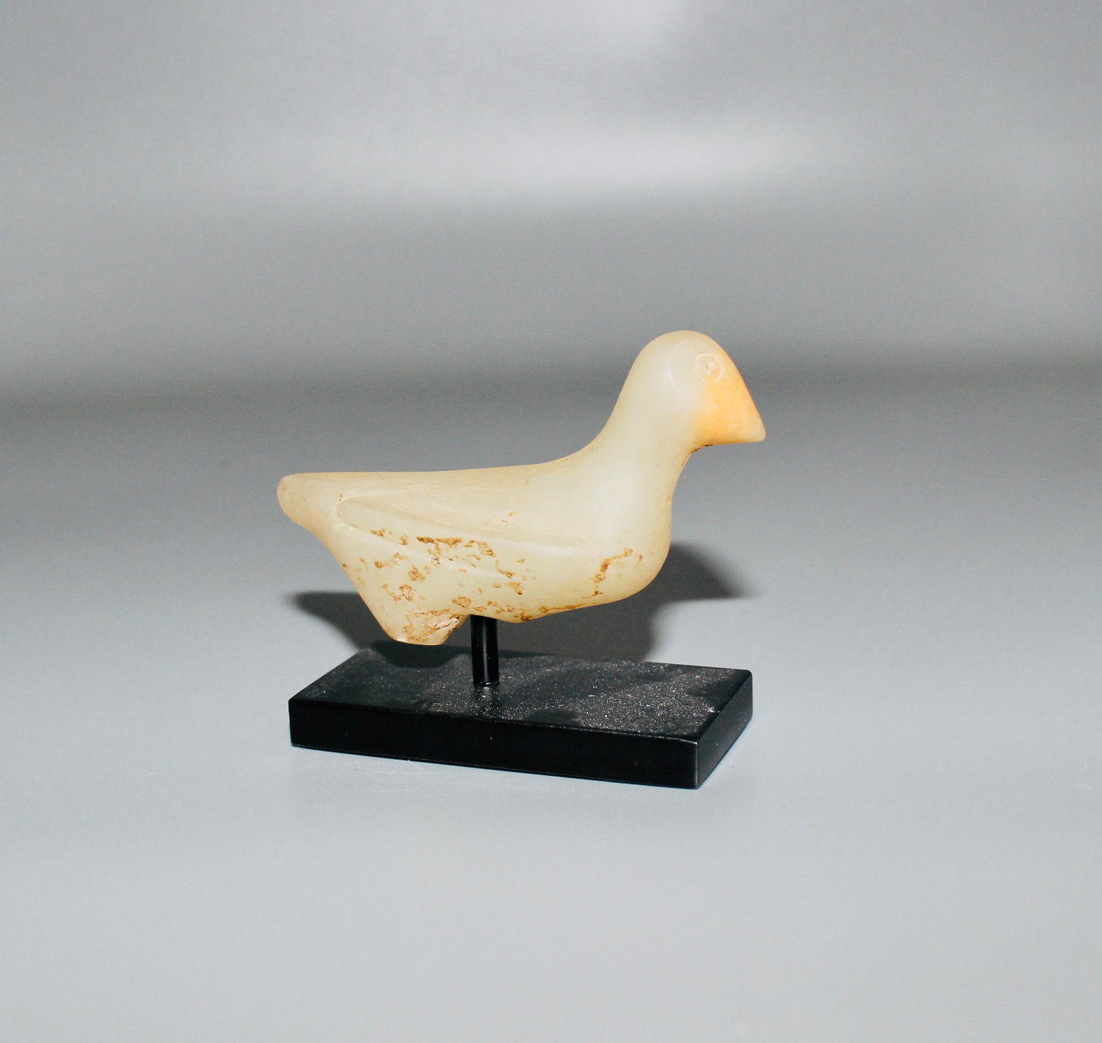 Near Eastern Alabaster Duck: Near Eastern, circa 3rd millenium BC. This early alabaster duck is abstract in style. The beak is nicely carved with the yellow section of the alabaster to render the beak. This piece has a nice smoot