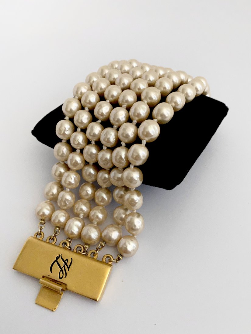 GRIPOIX PEARL KARL LAGERFELD PARIS VINTAGE BRACELET: An exceptional signed karl lagerfeld 6 strand gripoix pearl bracelet hand knotted on silk. The piece measures 8" long and 2 1/2" wide