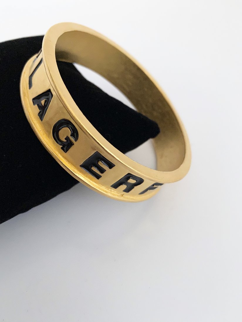 VINTAGE KARL LAGERFELD PARIS RUNWAY BRACELET BANGLE: An exceptional Karl Lagerfeld Paris 80's enameled logo bracelet. The bracelet measures 2 3/4" and is 3/4" thick