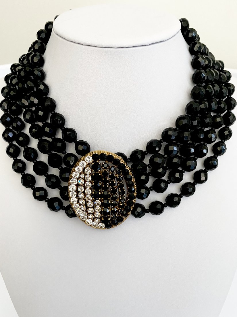 VINTAGE 80'S RUNWAY SCHERRER PARIS JET & CLEAR NECKLACE: An oversized 5 strand necklace by Scherrer Paris with facet cut jet 5 strand construction with a large center medallion of geometric set clear and jet rhinestones. The clasp has the same flirty color 