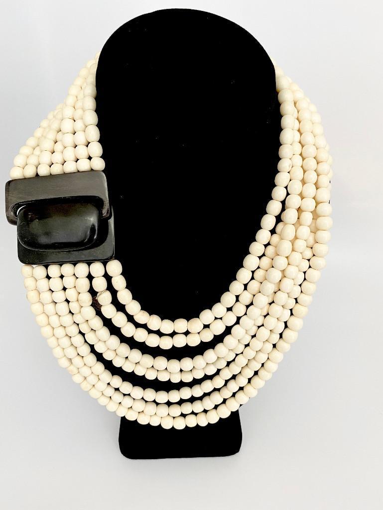 VINTAGE GERDA LYNGGAARD FOR MONIES BONE & HORN NECKLACE: A stunning bone and horn necklace with oversized buckle clasp signed by Gerda Lynggaard for Monies. 7 stands measures approximately 18"