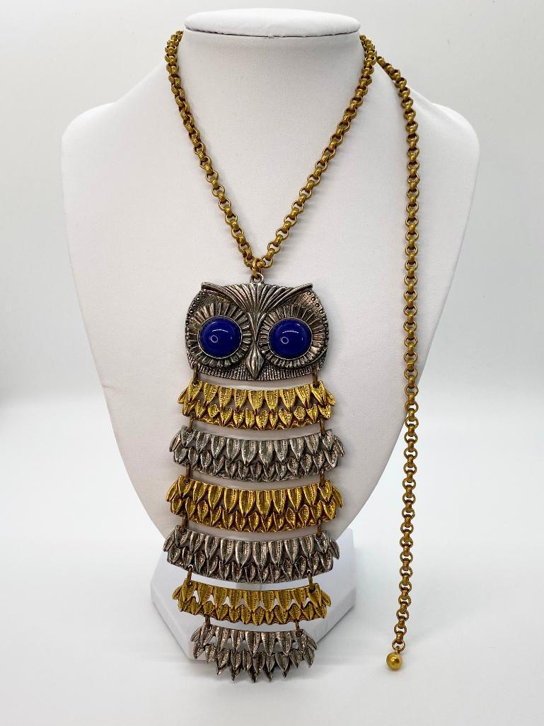 VINTAGE SIGNED GOLDETTE ARTICULATED RUNWAY OWL NECKLACE: Large signed Goldette hinged articulated silver-tone and brass owl pendant with blue glass cabochon eyes. Brass rolo chain with hook clasp is adjustable. Chain length 24". Pendant length 6".