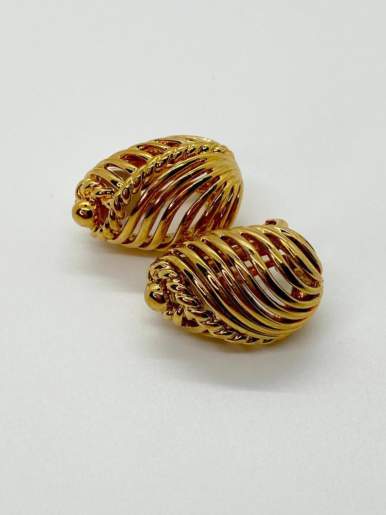 A SLEEK PAIR OF VINTAGE 80'S NINA RICCI PARIS EARRINGS: Vintage signed Nina Ricci gold-tone earrings. Clip back. 1" long.