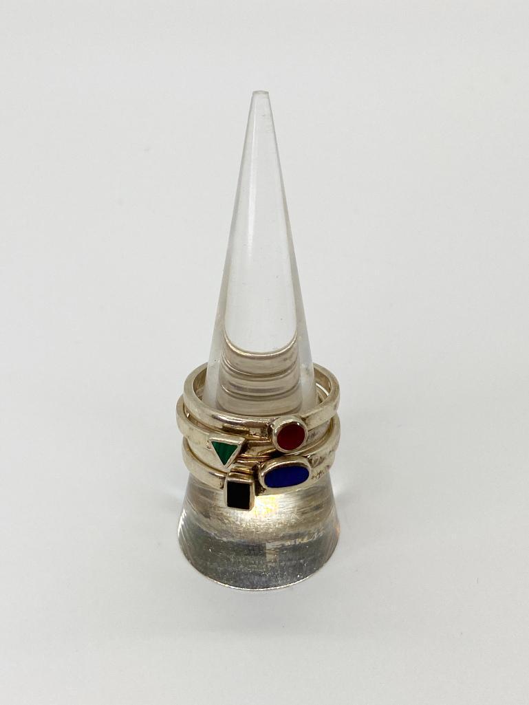 4 ESTATE STACKING RINGS WITH GEOMETRIC NATURAL RINGS: Set of 4 silver stacker rings with natural stone accents. Stamped .925 Thailand. Size 10. All stones have been tested with a Presidium Gem Tester II.