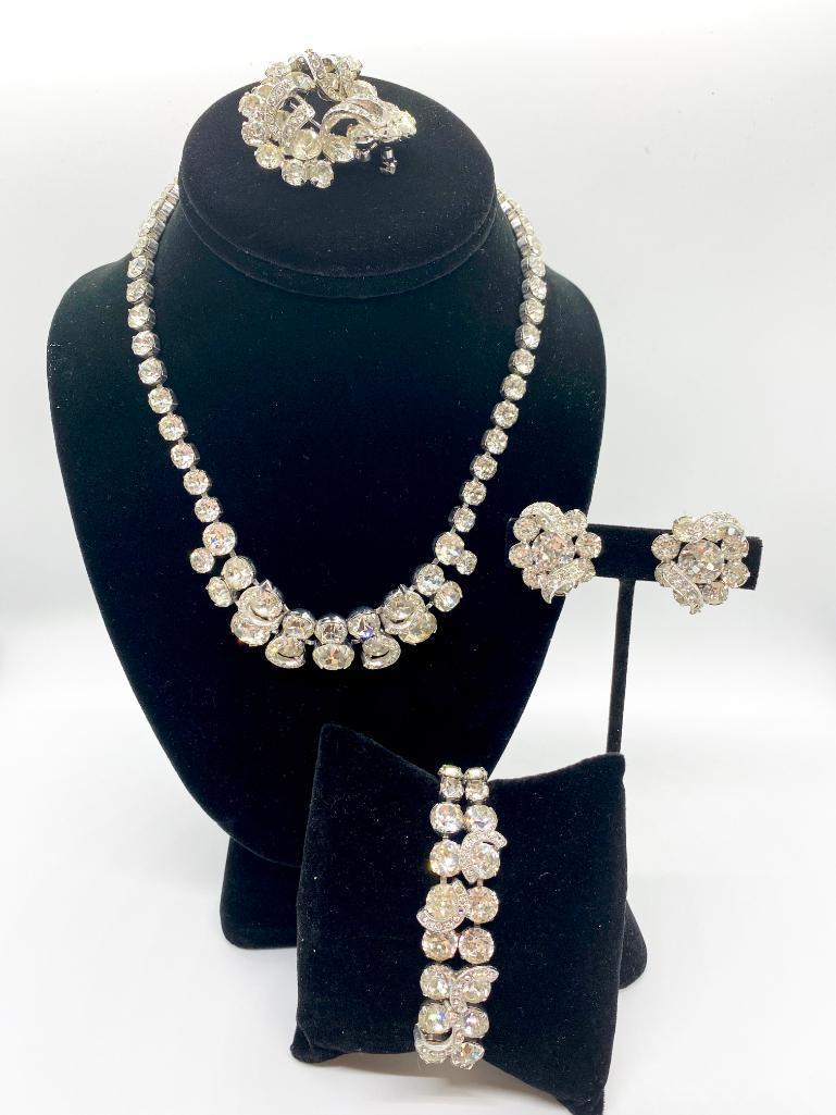 A COMPLETE 50'S VINTAGE EISENBURG SUITE NECKLACE: Complete suite featuring necklace, bracelet with safety chain, clip earrings and brooch. Beautifully prong-set rhinestones with scalloped accents. Necklace: 17" long Bracelet: 7" long Earrings: 1" lon