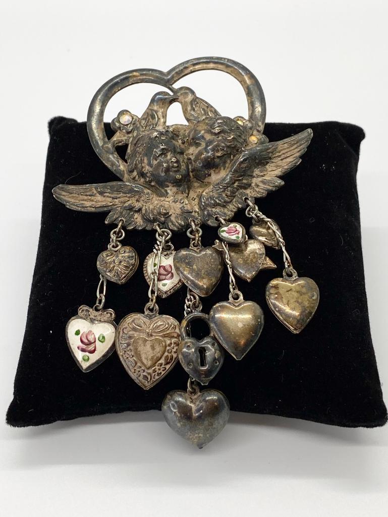 KISSING LOVEBIRDS & CHERUB DOZEN OF PUFFY HEARTS PIN: Kissing lovebirds, kissing cherubs, rhinestone accents, and 12 dangling puffy hearts, lockets or dangles, some with enamel decoration. 4 1/4" long.