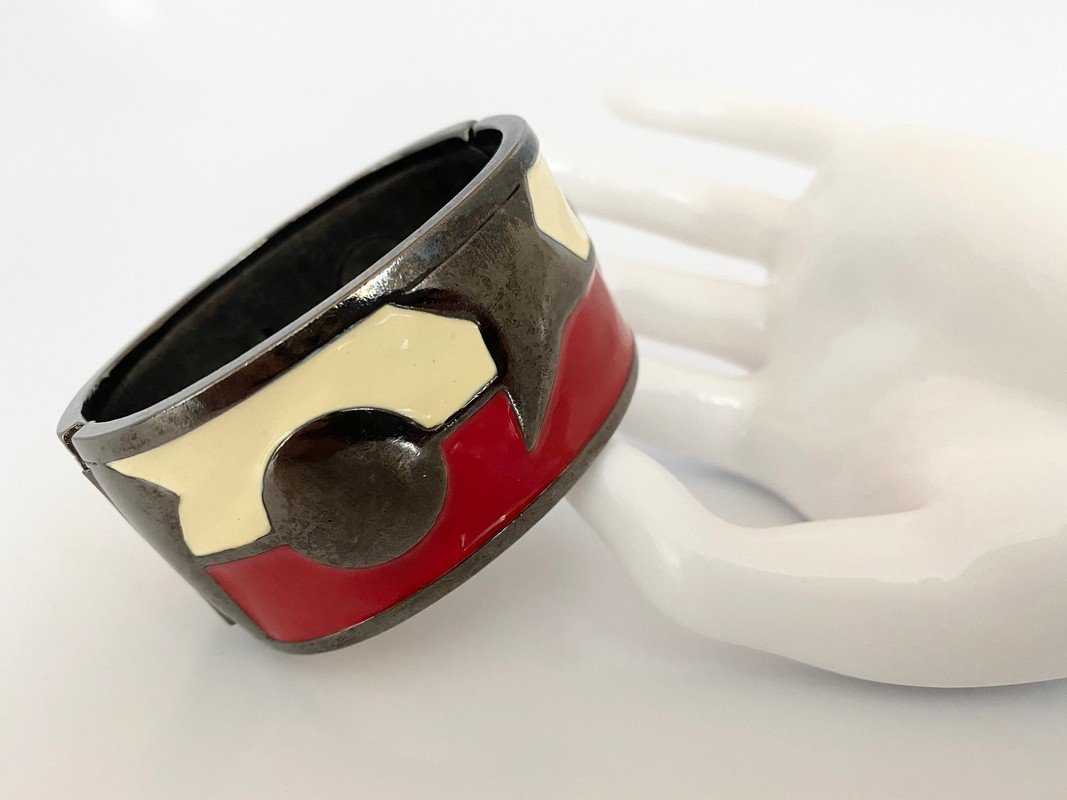 VINTAGE GUNMETAL OVERSIZED MOON & STAR ENAMEL BRACELET: An American made never worn 1960's bangle in gunmetal by Monet with heavy enameling. The bracelet measures 2 1/2" oval and stands 1 1/2" tall