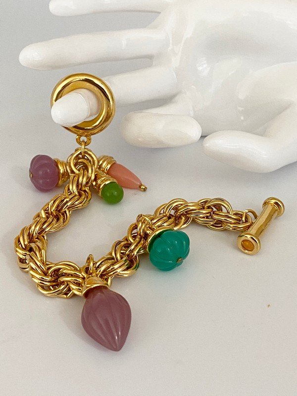VINTAGE DESIGNER 80'S OVERSIZED JEWELED CHARM BRACELET: A signed (illegible)5 hand carved resin jeweled bracelet. The bracelet measures 8" long with amazing faux jewels.
