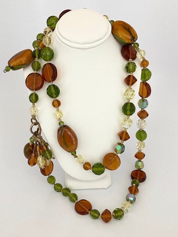 VINTAGE ERIKSON BEAMON RUNWAY GLASS & LEATHER NECKLACE: An oversized 44" with clasp erikson beamon unique glass runway necklace with additional 2" tassel strung on hide.