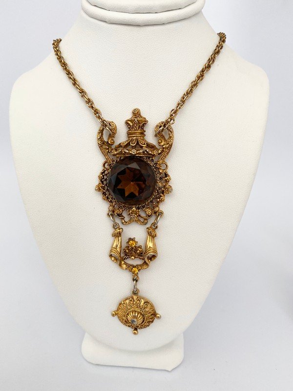 VINTAGE 70'S HIGH KARAT GOLDPLATED ETRUSCAN NECKLACE: a 24" clasped necklace with a 4" high karat goldplated etruscan pendant with smokey topaz centerpiece