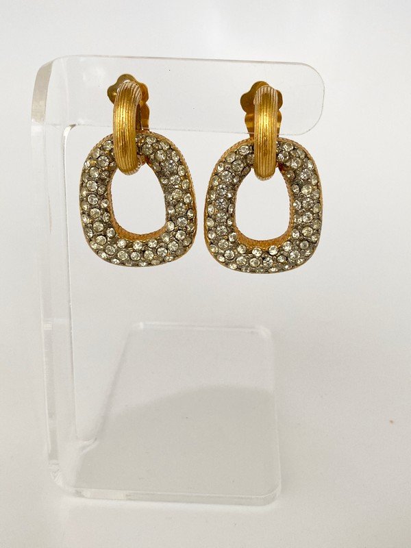 VINTAGE 60'S KENNETH LANE OVERSIZED JEWELED EARRINGS: A pair of vintage ear clips by Kenneth Lane with brushed goldtone finish and oversized jewel encrusted swinging door knockers. Each measures almost 2"