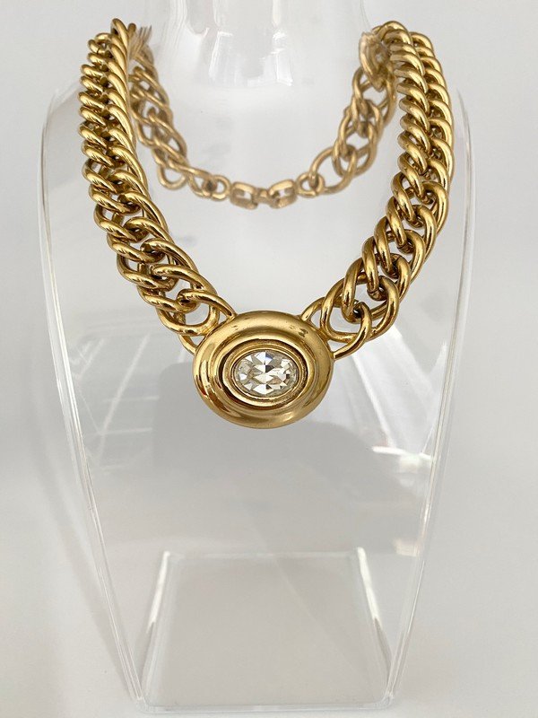 VINTAGE GIVENCHY PARIS RUNWAY OVERSIZED CLEAR NECKLACE: A massive signed Givenchy heavy goldtone necklace with oval glass stone in the centerpiece. The piece measures 17" with a centerpiece of 2"