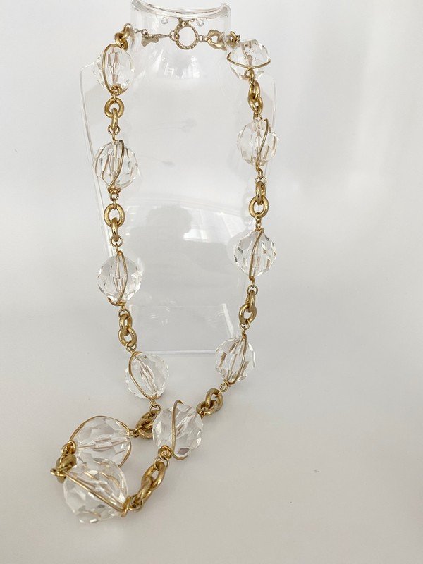 OVERSIZED VINTAGE 80'S LUCITE FACET CUT BALL NECKLACE: An oversized toggle clasped 24" necklace with facet cut lucite caged balls in goldtone