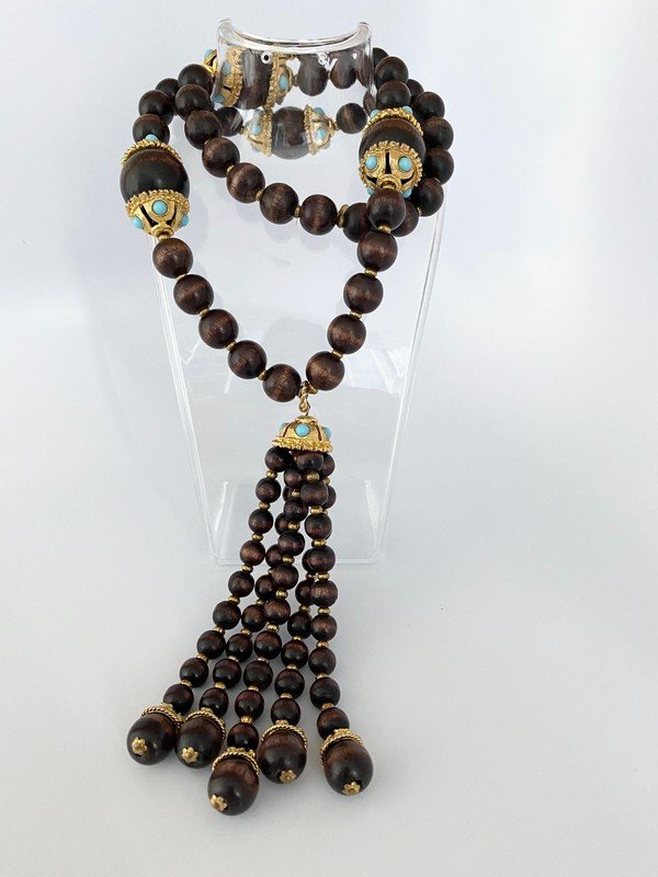 VINTAGE K.J.L KENNETH LANE MOGUL WOOD TASSEL NECKLACE: A rare vintage 28" necklace with oversized wood beads capped in heavy gold plated with turquoise cabochons with a 5 1/2" tassel. signed as shown