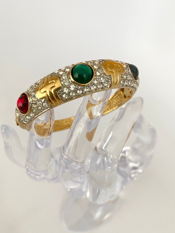 VINTAGE LOOK OF BVLGARI FAUX MOGUL JEWELED BRACELET: A jeweled bracelet with faux sapphire, ruby, and emerald cabochon with a 2 1/2" circular opening; hinged on the side