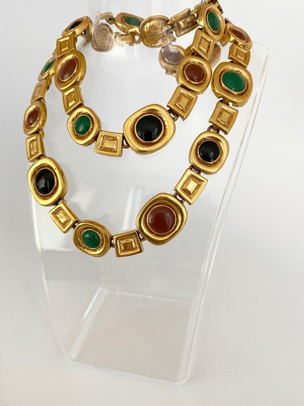 A VINTAGE HAND ENAMELED 80'S RUNWAY STATION NECKLACE: A 26" necklace with hand enameled stations in heavy gold plating, fold over clasp allows for layering. Unsigned designer piece.