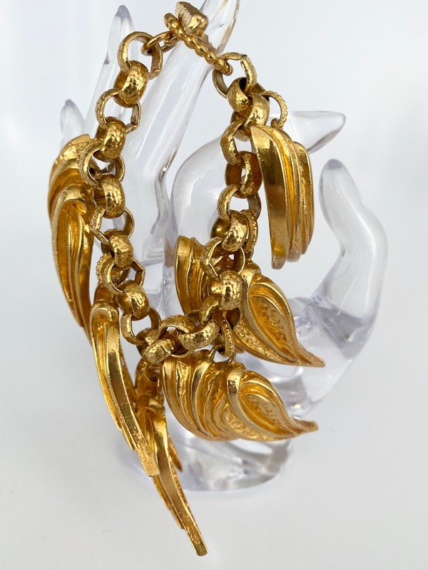 VINTAGE DOMINIQUE AURIENTIS PARIS LEAF CHARM BRACELET: A vintage signed Dominique Aurientis Paris multi charm bracelet with toggle clasp. The piece measures 7 1/2" with each charm measuring a large 2 1/4" each. Please check the follow lot for the matching